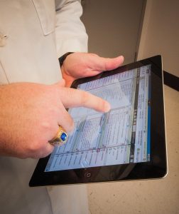 Image of a physician using an electronic charting system on an iPad